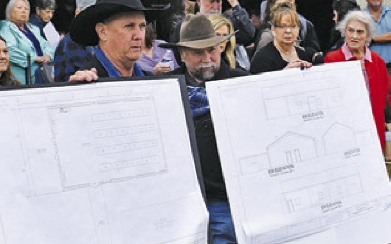 BLUEPRIINTS FOR a new fellowship and education building at the Burleson County Cowboy Church are displayed at their ground breaking ceremony on Sunday, Jan. 26