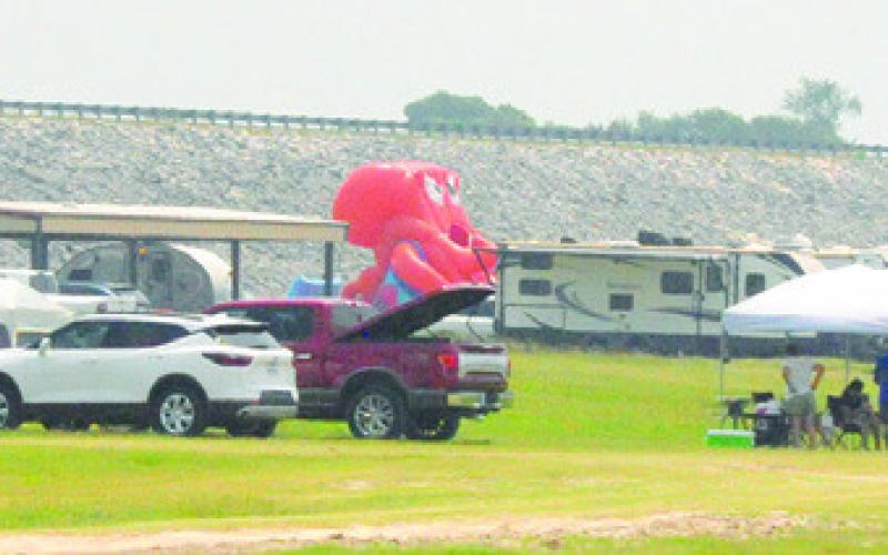 MANY TENTS AND RVS WERE parked around Lake Somerville for people to enjoy their long Memorial Day weekend. This cluster of campers in Welch Park also set up an inflatable octopus slide.