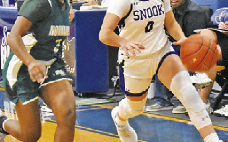 JADEYN LARA DRIBBLES the length of the court during Snook’s 50-34 win Friday. Tribune photo by Roy Sanders