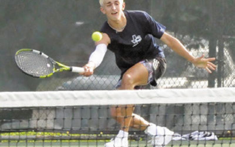 CALDWELL’S DYLAN Chapman lunges to hit the ball during a match at the UIL Class 4A Region 3 Tennis Tournament last week. Chapman won the boys singles title. Tribune photo by Denise Squier