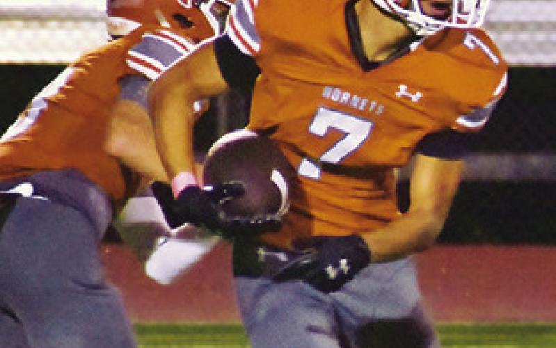 E.J. ROGERS carries the ball for Caldwell against Giddings last Friday.