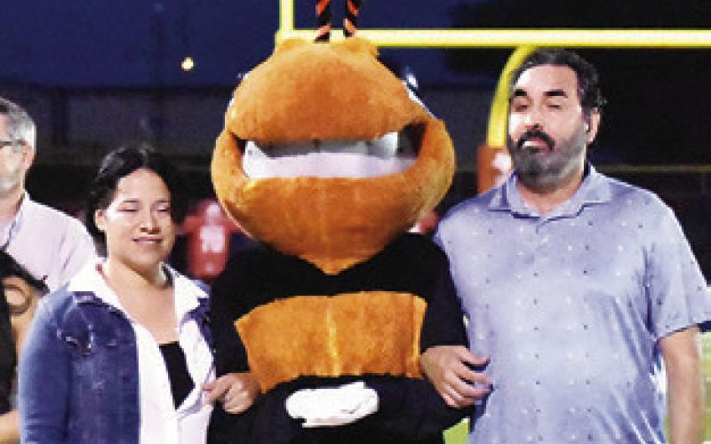 CALDWELL HIGH SCHOOL’S Caroline Segovia (Hank the Mascot) is with her parents Josh and Minerva Segovia at last Friday’s game.