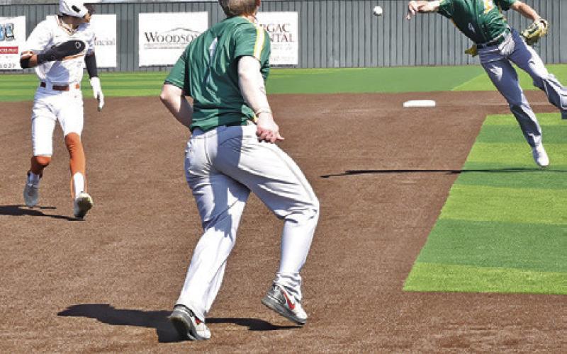 BLANE CASTANEDA of Caldwell runs for third as Lexington players try to tag him. -- Tribune photo by Roy Sanders