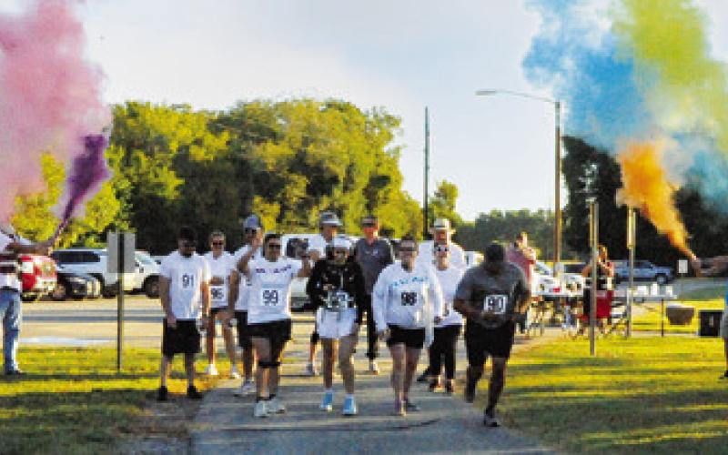 RUNNERS AND WALKERS WERE SHOWERED with color at the start