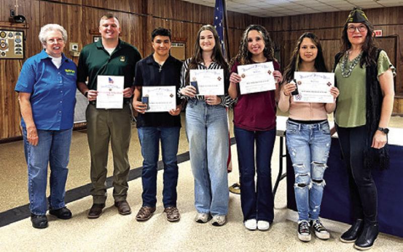 VFW POST NO. 4458 RECOGNIZED the winners of the Teacher of the Year, Voice of Democracy and Patriot’s Pen contests at its Thursday, Feb. 12, banquet. From L to R: Barbara Behler, Cody Savell, Grayson Behler, Emma Davis, Emily Strange, Alyssa Tenorio and Tina Smith. Tribune photo by Sabine Lazo