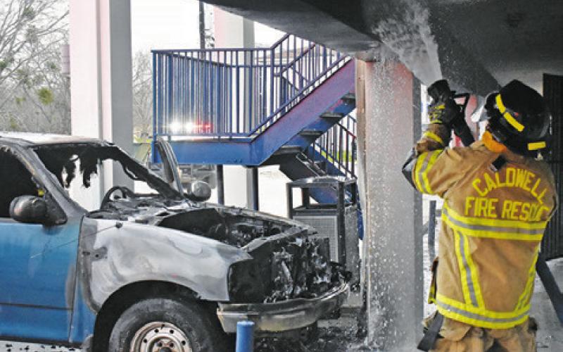 A CALDWELL FIREFIGHTER sprays water on the walls at Roadway Inn at this truck fire on Monday, March 4, in Caldwell.