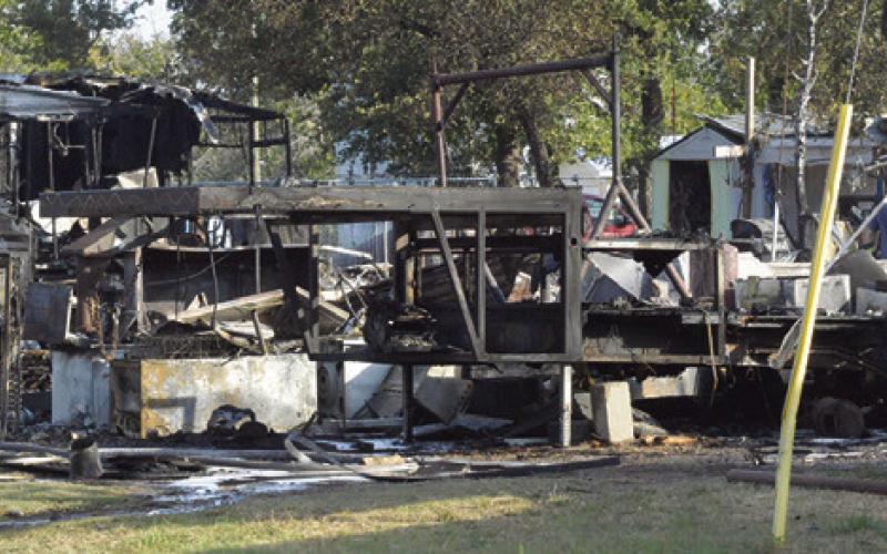 THESE RVs ARE destroyed by fire on Monday, August 24, off Park Road 4. Tribune photo by Denise Squier