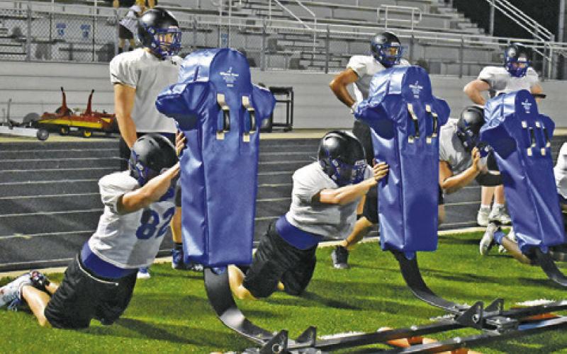 SNOOK’S OFFENSIVE LINE works on technique during this practice.