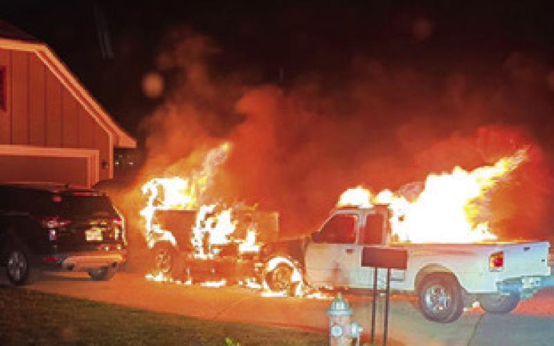 FIRE ENGULFS THESE pickups on Meadow Brook Drive.