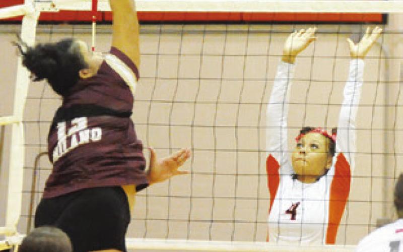 SOMERVILLE’S GABBY JACKSON prepares to attempt to block a hit from a Milano player during the Lady Yegua-Lady Eagle match last Friday in Somerville. -- Tribune photo by Denise Squier