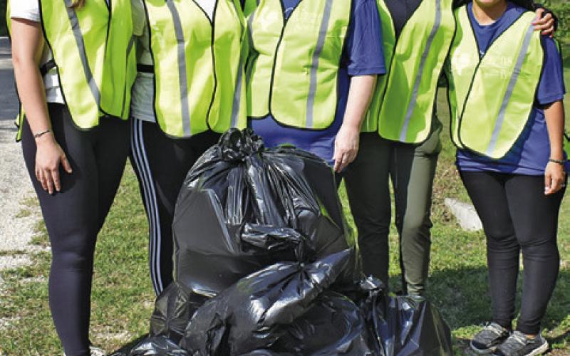 THIS CITIZENS STATE Bank crew works early Saturday, May 10, at the Burleson County Spring Clean Trash Off along County Road 409. They include, from left, Kendra Wiatrek, Savannah Zuniga, Melanie Schulte, Norma Medina and Veronica Castillo.