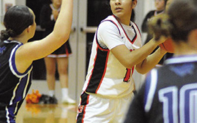 ANETTE REYNA looks for help from a teammate during the Somerville-Mumford game last Friday night at the Yegua Gym. Tribune photo by Denise Squier
