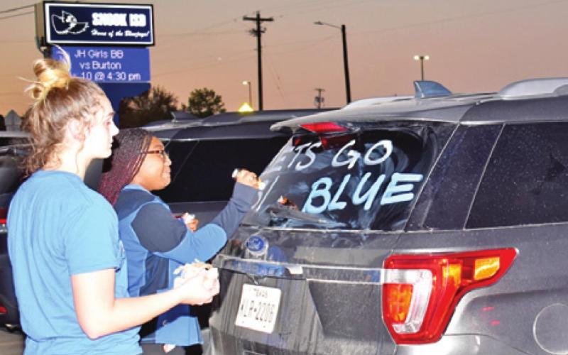 STUDENTS DECORATE THESE vehicles on Thursday night, Nov. 11, prior to Snook’s playoff game with Rocksprings.