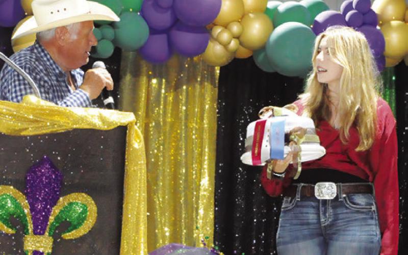 BAKED FOODS AUCTIONEER Charles Doonan has a conversation with Sarah Boniol during last week’s Baked Foods sale at the Burleson County Fair. Tribune photo by Denise Squier