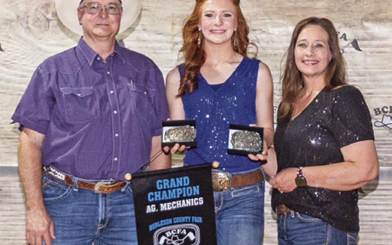 GRAND CHAMPION IN Ag Mechanics, Cayle Canon is pictured with Joe and Cassie Baldwin. Photo courtesy of Jeffries Livestock Marketing