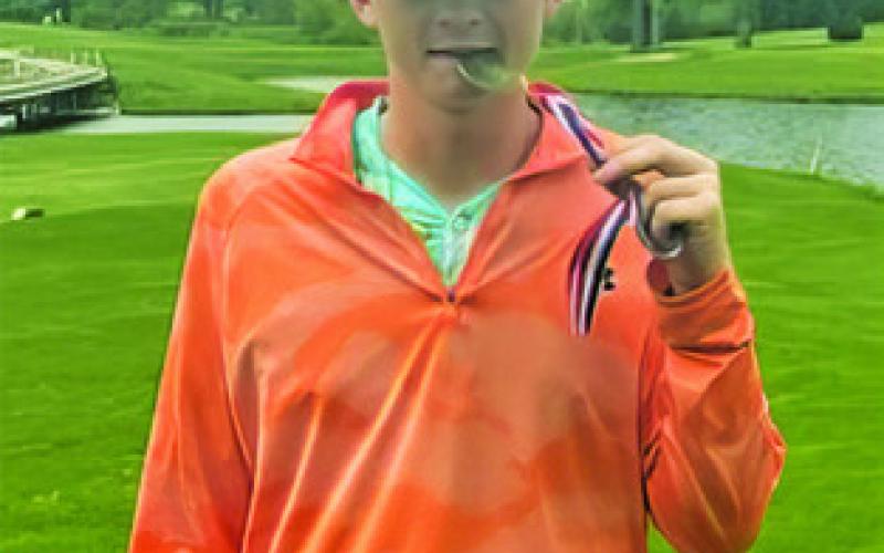 BARRETT HOWE wins the district golf championship in the individual competition.