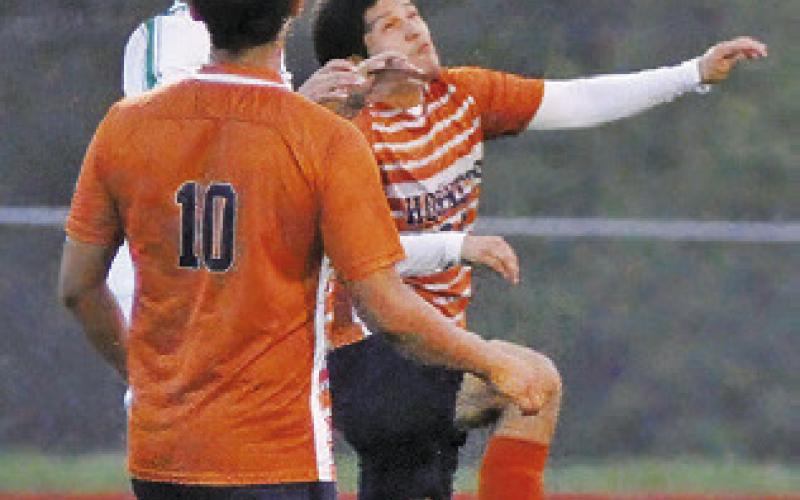 GUSTAVO SANTOS Ramos heads the ball during the Caldwell-Taylor game on Friday. Also pictured is Daniel Morales.
