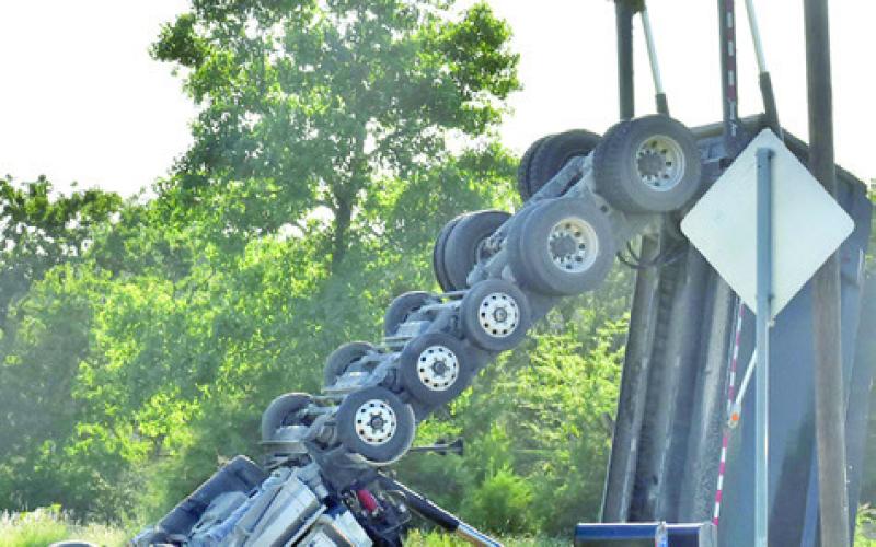 THIS DUMP TRUCK overturned on Friday, June 6, in an accident off State Highway 36 South. The driver was flown to a Temple hospital. Tribune photo by Roy Sanders
