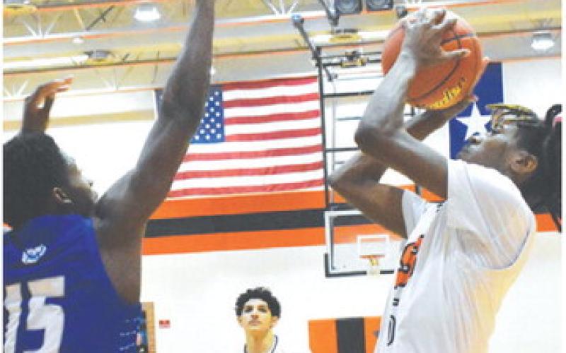 BRANDYN CARTER TAKES a shot against Bartlett in the first game of the tournament. -- Tribune photo by Roy Sanders