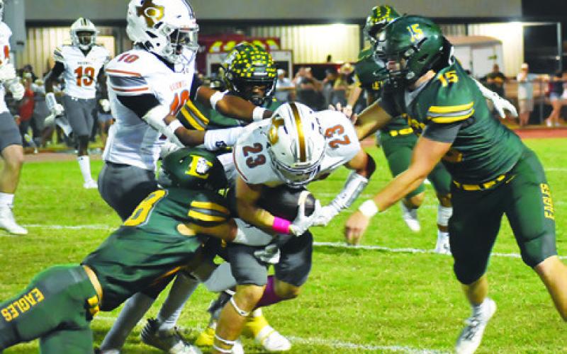 BRAXTON FRITCHER CARRIES the ball against Lexington last Friday in Lexington. The Hornets lost 52-7. Tribune photo by Roy Sanders