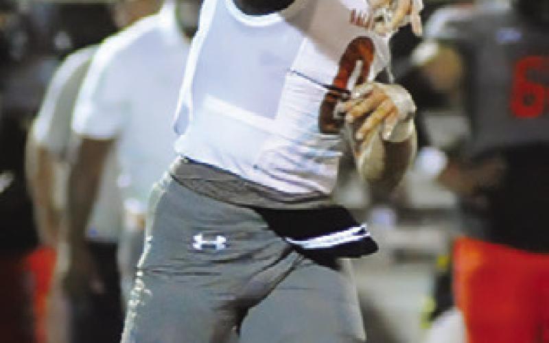 COY BECKA of Caldwell hurls this pass against Gonzales last Friday.