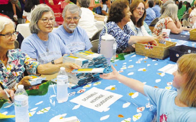 THE DEANVILLE HERITAGE Foundation gave Burleson County students boxes of pencils at Monday’s “Back-to-School Blast” at the Burleson County Expo Center. Tribune photo by Denise Squier