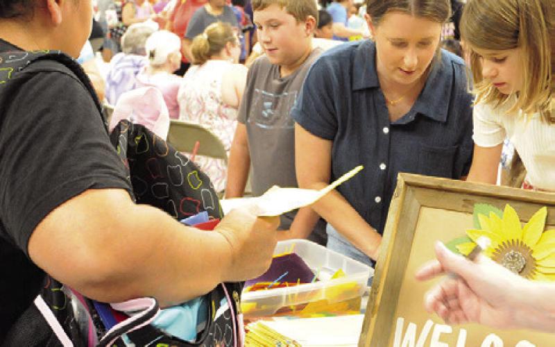 MEMBERS OF PROVIDENCE BAPTIST Church gave out binder dividers to fifth through 12-grade students at Monday’s “Back-to-School Blast” at the Burleson County Expo Center. Tribune photo by Denise Squier