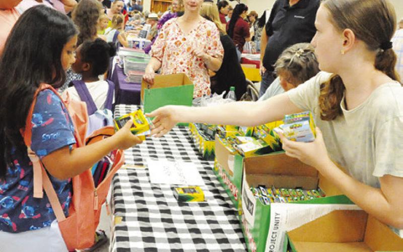 CALVARY BAPTIST CHURCH of Caldwell gave out crayons during Monday’s “Back-to-School Blast” at the Burleson County Expo Center. Pictured are members of Calvary Baptist Church. Tribune photo by Denise Squier