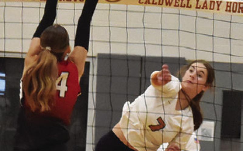 LYDIA GIESE gets the ball past a BVCHEA Homeschool blocker during a Caldwell win in 2025. During this match, Giese reached 1,000 career assists. Tribune photo by Roy Sanders