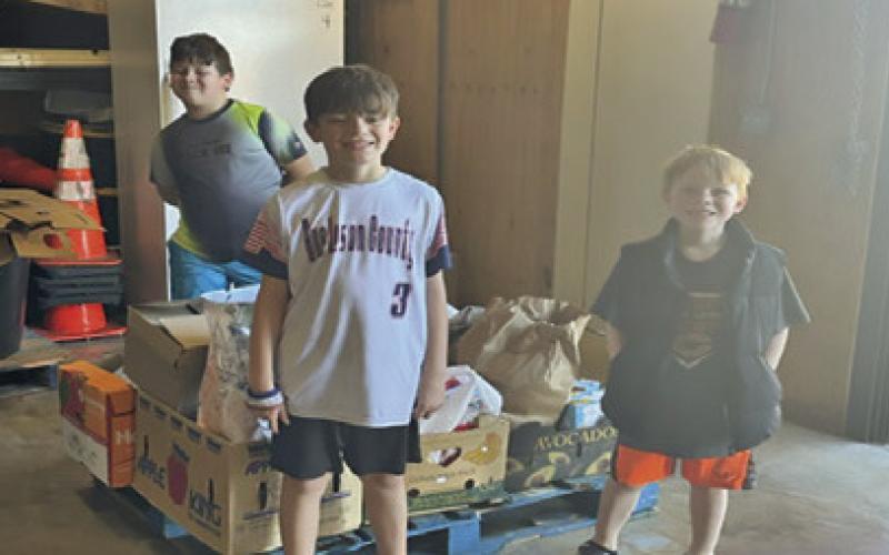 ON SATURDAY, FEB. 1, Caldwell Pack 181 collected nonperishable food for the Elizabeth Lutheran Church Pantry. They collected 250 pounds of food. Pictured, from left, are Jake-Ryan Baron, Nicholas Sandage and Lucas Sandage. Photo courtesy of Pam Cantey