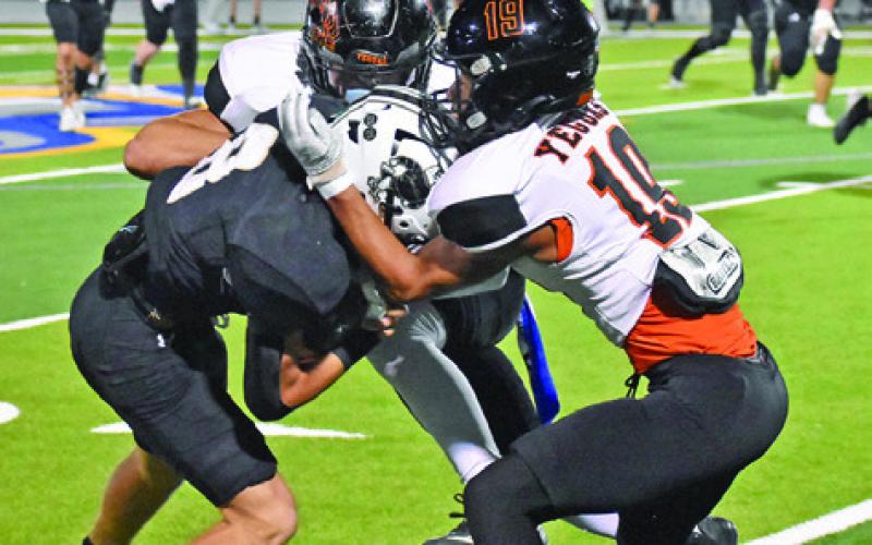 JAILLE DEERE AND Kaleb Leang make a tackle against Junction last Friday in the bi-district game in Lago Vista. Tribune photo by Roy Sanders