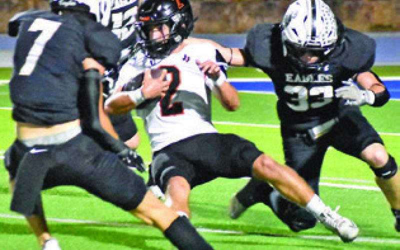 COLT HOLTON HOLDS onto the ball in the bi-district playoff game last Friday against Junction in Lago Vista. Tribune photo by Roy Sanders