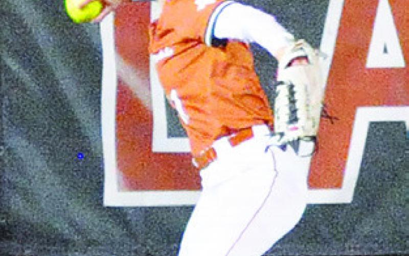 BREANN SIMS sets to throw the ball from the outfield after a Leon batter hit the ball to the warning track. -- Tribune photo by Denise Squier