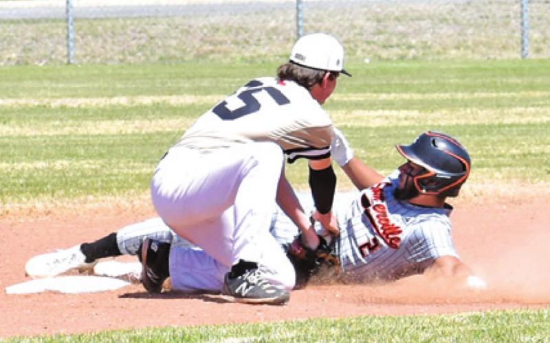 SOMERVILLE’S JULIAN FRAYRE slides into base against RTC.