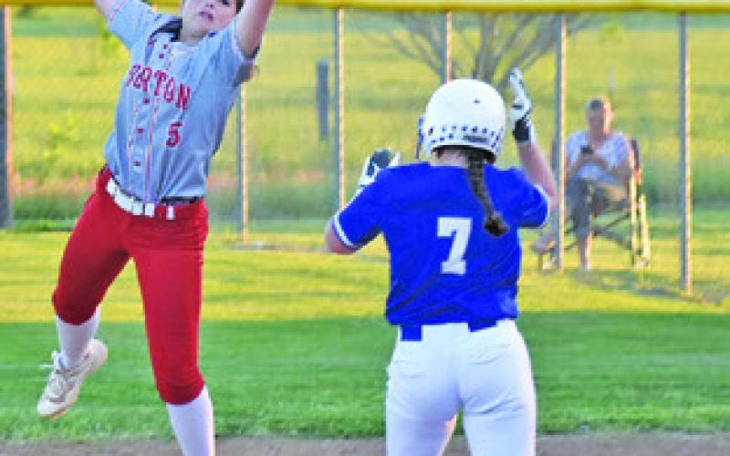 SNOOK’S KALYN COOPER REACHES first base on a wild throw to first during the Snook-Burton game last Friday night. Also pictured is Burton first baseman Melanie Wood. -- Tribune photo by Roy Sanders