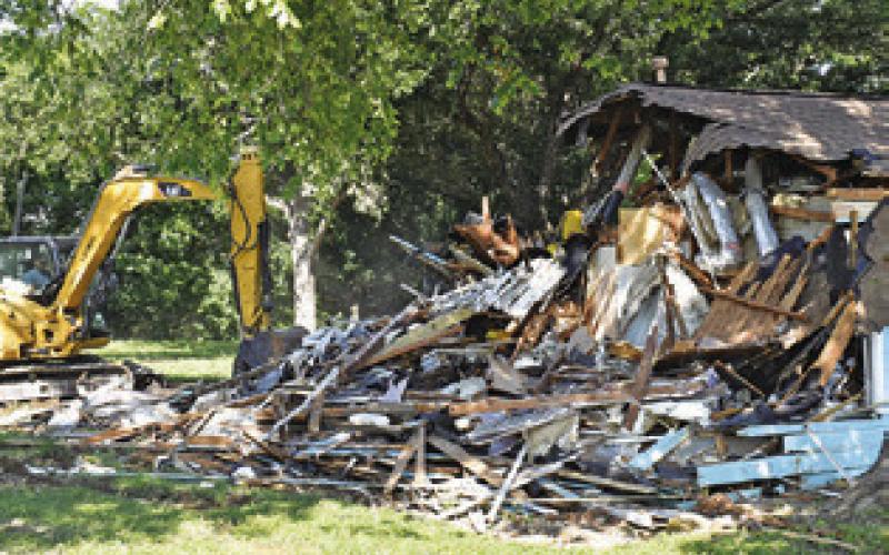 THE OLD BUILDING is demolished at 203 N. Main Street in Caldwell at the new site of the Texas Czech Genealogical Society.