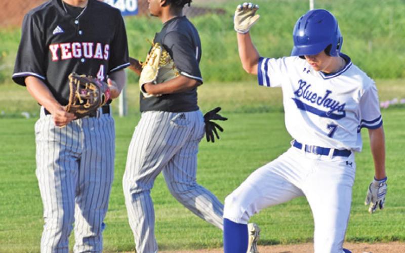 SNOOK’S J. BEAUX Hruska gets to base. Also pictured is Somerville’s Johnny Legg and Arvis Burns. -- Tribune photo by Roy Sanders