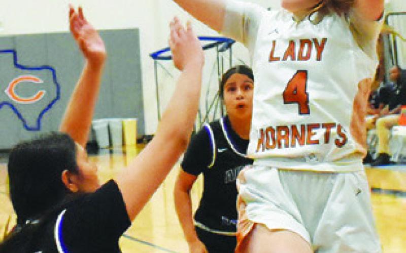 CADIE COSTON takes a shot over an Austin Achieve defender during Caldwell’s win Friday night. -- Tribune photo by Roy Sanders