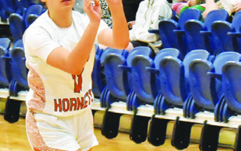 CHASSIDY ROGERS passes the ball to a teammate during the Caldwell-Austin Achieve game last Friday night at Hornet Gym.