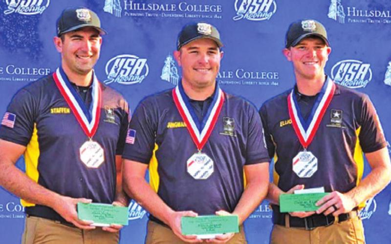PHILLIP JUNGMAN (center) poses with U.S. Army Marksmanship Unit (USAMU) teammates on the medal podium after winning the national championship in Men’s Skeet. Pictured with him are bronze medalist Mark Staffen (left) and silver medalist Christian Elliot (right).
