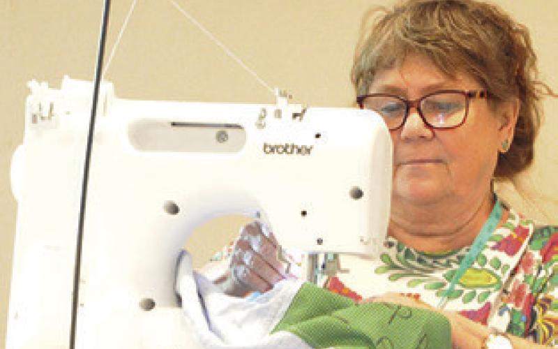 SNOOK EEA MEMBERS hosted a “sew-in” to support The Blessing Box Project, which provides mastectomy pillows and drain shirts for women battling breast cancer. Tribune photo by Denise Squier