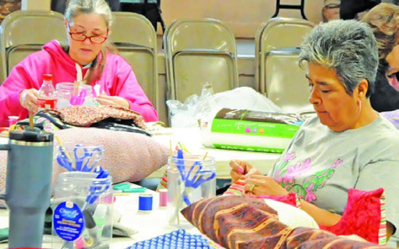 SEWING BY HAND AND BY machine helped make several mastectomy pillows and drain shirts for women battling breast cancer through Saturday’s event in Snook to help The Blessing Box Project. Tribune photo by Denise Squier