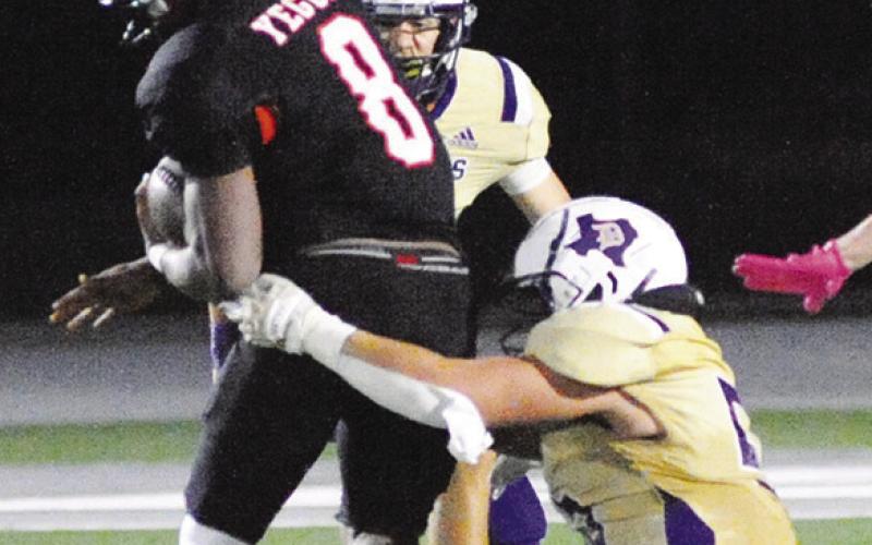 JA’KEITH DANIELS runs with the ball, trying to evade D’Hanis tacklers during Somerville’s bi-district win last Friday night. Tribune photo by Denise Squier