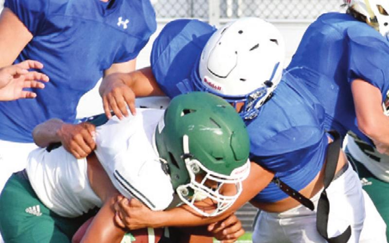JONATHON QUEVEDO of Snook makes a tackle as teammate David Toler approaches in the Normangee scrimmage last Friday in Snook.