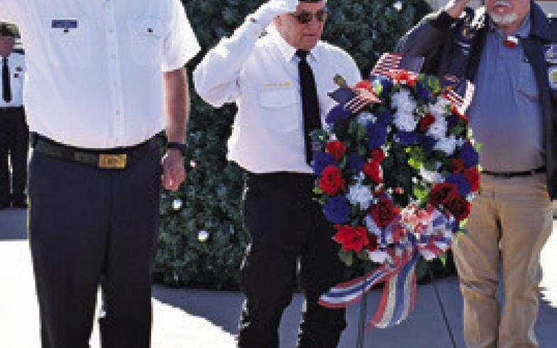 LEE HOERMANN, HENRY Probst and John Mayson place the wreath at the Veterans Memorial during the Veterans Day ceremony.