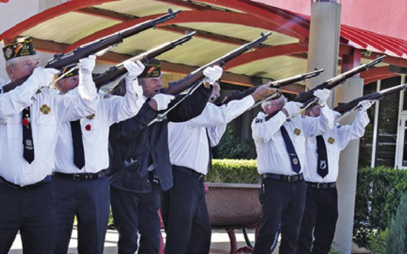THE CALDWELL VFW Rifle Honor Guard fires its salute during the Veterans Day ceremony on Tuesday at the Caldwell Civic Center.