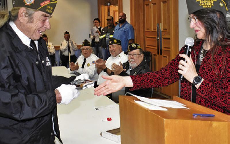 TINA SMITH PRESENTS Glenn Rhodes this plaque for his years of service as captain of the VFW Rifle Honor Guard.