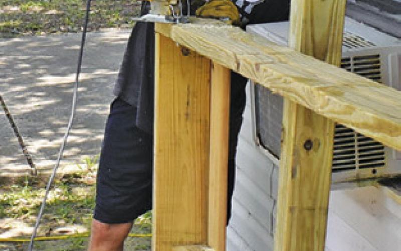 A U.M. ARMY adult leader works on Monday at this Somerville residence.