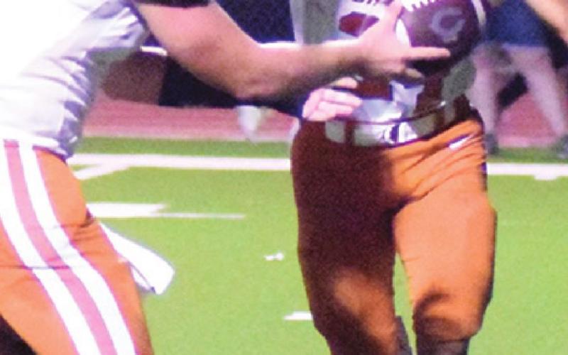 ADIAN TORRES OF Caldwell takes this handoff from quarterback Travis Balcar.