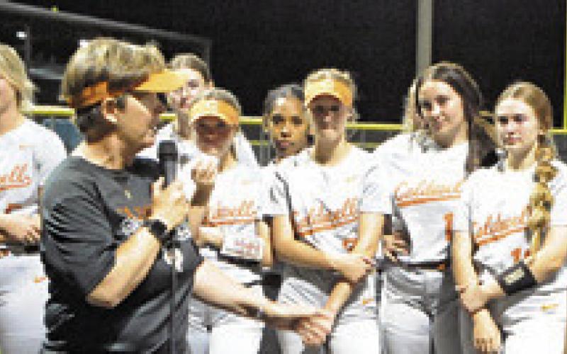 CALDWELL SOFTBALL COACH Wendy Weiss addresses the current Lady Hornets during a speech Friday night. Weiss was honored after the Caldwell-La Grange game for her 29 years of coaching in Caldwell.